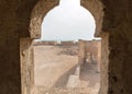 Ruined ancient Arab pearling, fishing town Al Jumail, Qatar. The desert at coast of Persian Gulf. View out of minaret window. Royalty Free Stock Photo