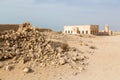 Ruined ancient old Arab pearling and fishing town Al Jumail, Qatar. The desert at coast of Persian Gulf. Pile of stones.