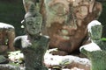 Ruined ancient stone buddha statue in front of huge buddha head statue wallpaper, broken body art crafting souvenir sculpture, sit