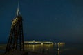 Ruined antenna near the sea at beach. Beautiful night sky. Starry night and Milky Way Royalty Free Stock Photo