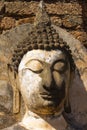 Ruined Buddha's hade in Wat Phra Si Ratana Mahaphat, Si Satchanalai, Thailand