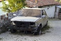 Ruined car next to paved road Royalty Free Stock Photo