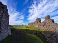 Ruined castle walls on top of grassy hill in Wales Royalty Free Stock Photo