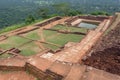 Ruined city on ancient Sigiriya rock with archeological area and pool, Sri Lanka. UNESCO world heritage site from 1982 Royalty Free Stock Photo