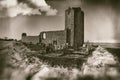 Ancient church ruins with small graveyard surrounded with stone wall in sepia Royalty Free Stock Photo