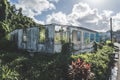 Ruined and destroyed building with overgrown plants around. Frame, columns and wall left from an old house Royalty Free Stock Photo