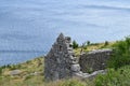 Landscape.Ruined stone house on the coast with sea and wind