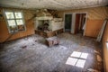 Ruined interior of an old wooden house with rusty stoves