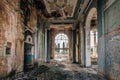 Ruined large hall interior overgrown by plants and moss