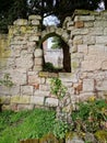 Ruined medieval priory wall and window