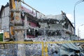 Ruined multi-storey building. An excavator demolishes a multi-storey building with a chisel tool. Technique destroys the building