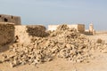 Ruined old Arab pearling and fishing town Al Jumail, Qatar. Pile of stones. The desert at coast of Persian Gulf. Royalty Free Stock Photo