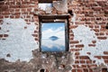 Ruined old brick wall window with sky, sea and island view. Freedom, dream, imagination or isolation Royalty Free Stock Photo