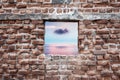 Ruined old brick wall window with sunset sky and sea view. Freedom, dream, imagination or isolation Royalty Free Stock Photo