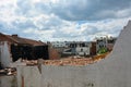 A ruined old building in the form of a pile of bricks and a half-destroyed wall