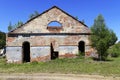 Ruined old red brick building. Wall of an old factory with semicircular arches in the summer on a sunny day. There are trees Royalty Free Stock Photo