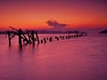 Ruined pier into the sea, idyllic sunset Royalty Free Stock Photo