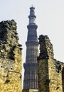 Ruined Quwwat ul-Islam Mosque with Qutb Minar tower in background at Qutub Minar complex Royalty Free Stock Photo