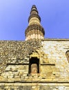 Ruined Quwwat ul-Islam Mosque with Qutb Minar tower in background at Qutub Minar complex Royalty Free Stock Photo