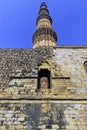 Ruined Quwwat ul-Islam Mosque with Qutb Minar tower in background at Qutub Minar complex Royalty Free Stock Photo