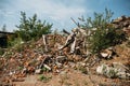 Ruined red brick building destroyed by earthquake or tornado or war or other disaster. Demolished house. Debris and trash