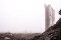 The ruined remains of a building with a pile of concrete rubble and bricks against the background of a building wall in Royalty Free Stock Photo