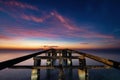 Ruined sea pier in the early morning amidst the dawn Royalty Free Stock Photo
