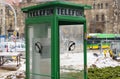 Ruined telephone booth with a broken glass door