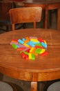 The ruined tower of Jenga game. Colored blocks scattered on table Royalty Free Stock Photo