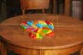 The ruined tower of Jenga game. Colored blocks scattered on table Royalty Free Stock Photo