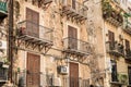 The ruined wall with balconies of an old house in the old city of Palermo.