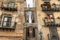 The ruined wall with balconies of an old house in the old city of Palermo.