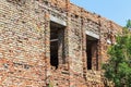 Ruined wall of building. Abandoned to unnecessary houses are destroyed. Self-destruction of abandoned buildings. Conceptually, cri Royalty Free Stock Photo