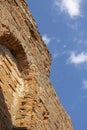 The ruined wall of the old catholic chapel. The ruins of an old church. Brick wall en blue sky background