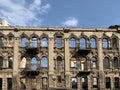 The ruined wall of the old house against the sky. The ruins of a collapsed historic building in the city center. Demolition of an Royalty Free Stock Photo