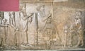 Ruined wall of Persepolis showing king Darius life on relief in National Museum of Iran Royalty Free Stock Photo