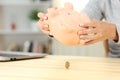 Ruined woman checking piggy box content