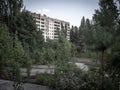 Ruins of an abandoned residential block among new grown trees in Pripyat city, Chernobyl