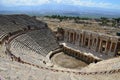 The ruins of the amphitheater of the ancient city of Hierapolis on the background of the mountains near Pamukkale, Turkey