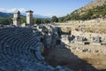 Ruins of amphitheater and Rock tombs in Xanthos Ancient City, Turkey. Sunny day, Old Lycian civilization Royalty Free Stock Photo