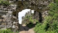 ruins of an ancient castle. arched entrance and the remains of ancient half-ruined walls