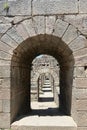 Ruins ancient city stone temple in izmir, top arches, keystones, columns, torso statue, high stone wall