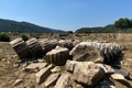 Ruins ancient city stone temple in izmir, top arches, keystones, columns, torso statue, high stone wall