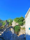 The ruins of an ancient fortress. old thick stone walls of a European fortress overgrown with greenery in the mountains. Doors and Royalty Free Stock Photo