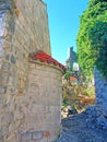 The ruins of an ancient fortress. old thick stone walls of a European fortress overgrown with greenery in the mountains. Doors and Royalty Free Stock Photo