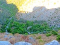 The ruins of an ancient fortress. old thick stone walls of a European fortress overgrown with greenery in the mountains. Doors and Royalty Free Stock Photo