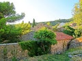 The ruins of an ancient fortress. old thick stone walls of a European fortress overgrown with greenery in the mountains. Doors and Royalty Free Stock Photo