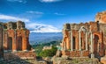 Ruins of ancient Greek theater in Taormina and Etna volcano in the background Royalty Free Stock Photo