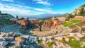 Ruins of ancient Greek theater in Taormina and Etna volcano in the background Royalty Free Stock Photo
