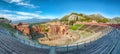 Ruins of ancient Greek theater in Taormina and Etna volcano in the background Royalty Free Stock Photo